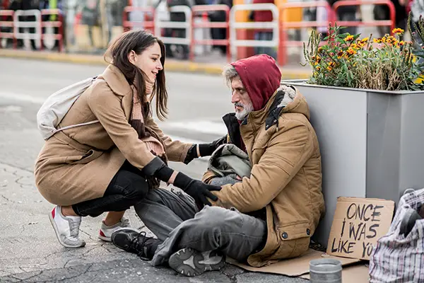 Homeless man with woman helping 6x4